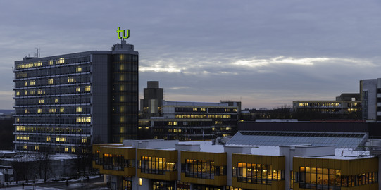 Maths Tower and dining hall at dusk in winter.